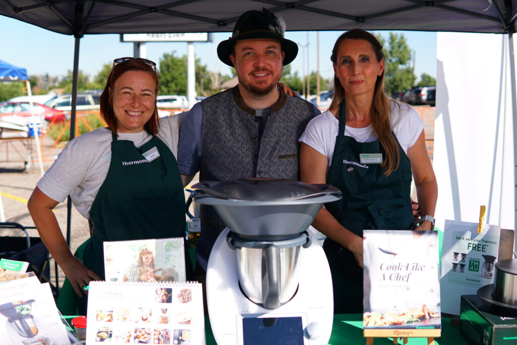 Vendors pose for the camera at their booth during Oktoberfest