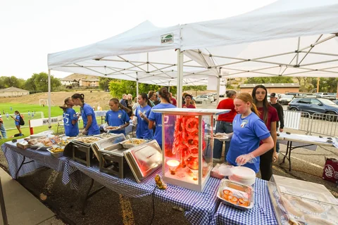 The outdoor food-service team beside the serving table