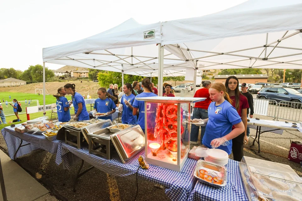 The outdoor food-service team beside the serving table