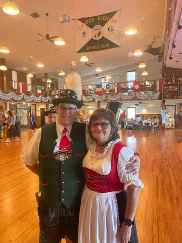 Two guests in traditional clothing posing in the clubhouse