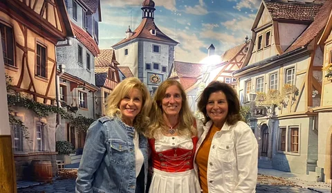 Three friends at the photo backdrop
