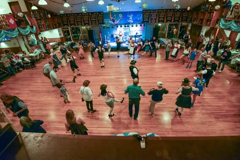 A circle of guests and performers on the dance floor