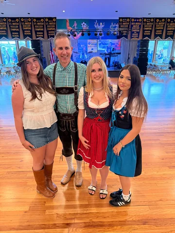 Four guests posing together on the clubhouse dance floor