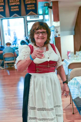 A guest in traditional dress raising a glass