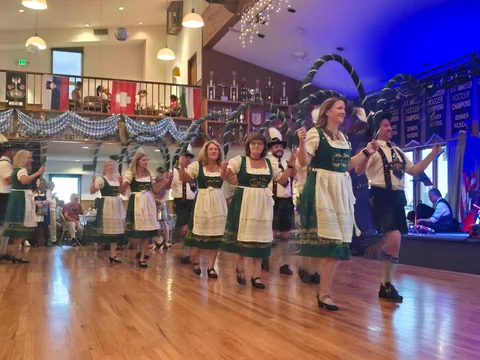 Performers raising decorated hoops during a group dance