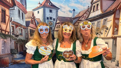 Friends posing with Oktoberfest photo props