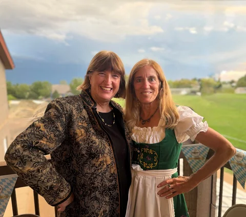 Two guests smiling together outside