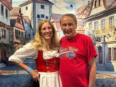 Two guests smiling at the photo backdrop