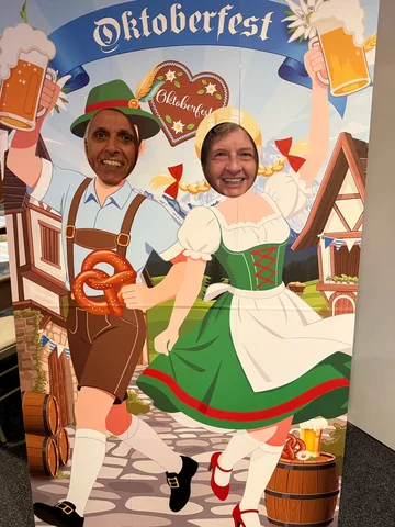 Guests posing through an Oktoberfest photo board