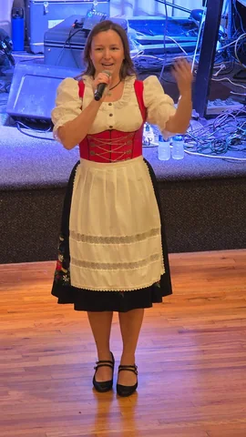 A performer in traditional dress in front of the stage