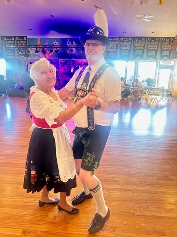 Two performers dancing together in the clubhouse