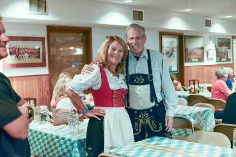 A couple smiling together beside the tables