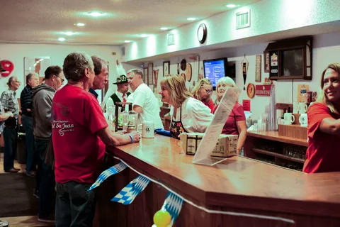 Guests and volunteers at the clubhouse bar