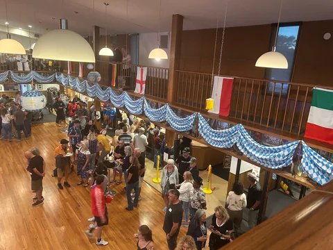 Guests gathered beneath blue-and-white clubhouse decorations