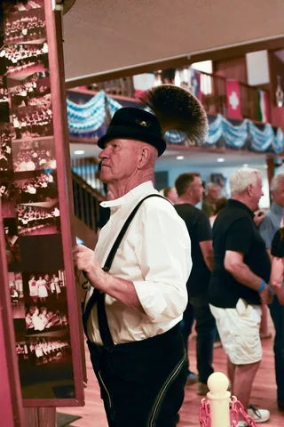 A guest in traditional dress by the clubhouse doorway
