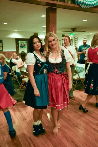 Two guests in dirndls posing together